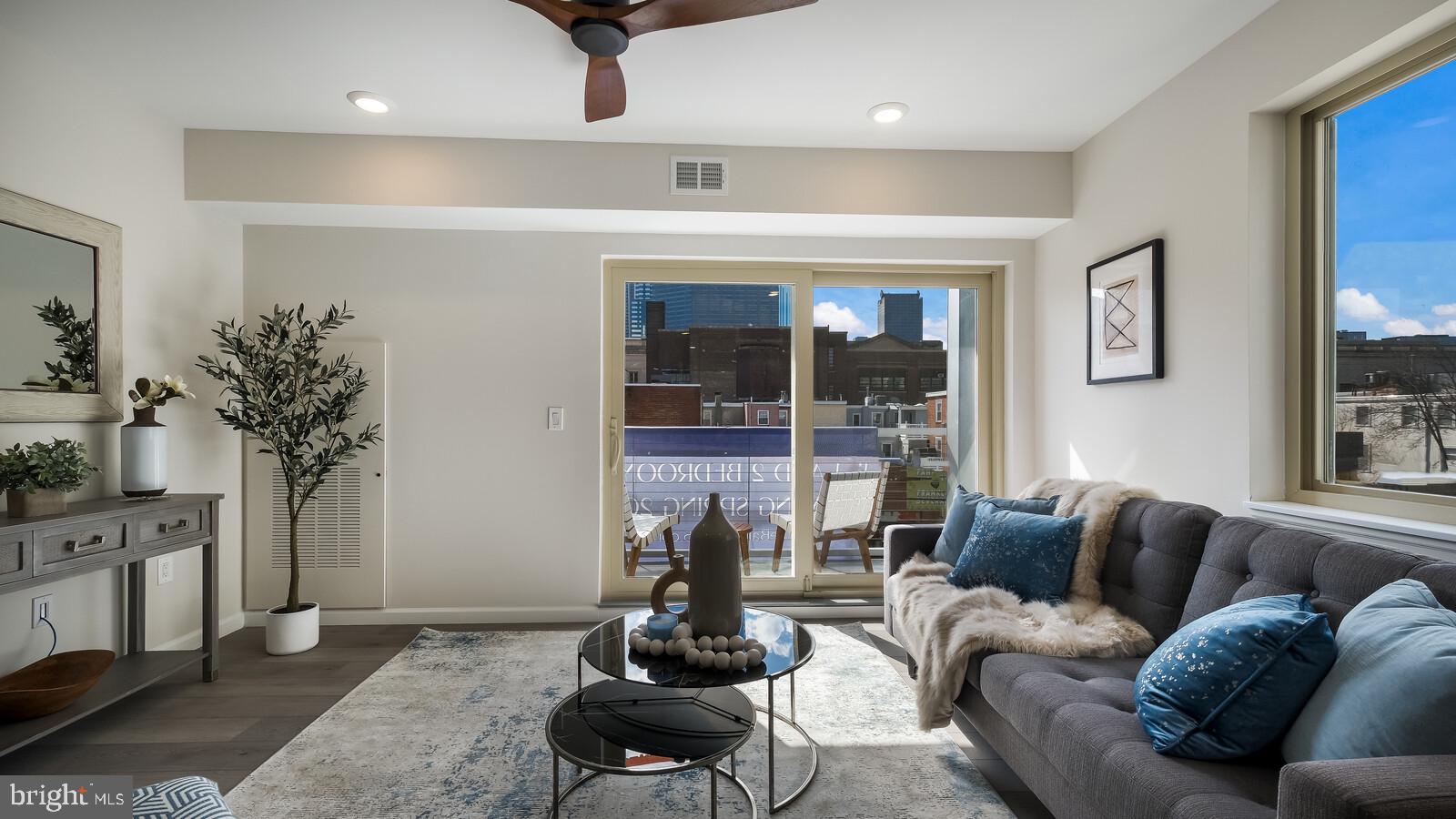 1825 Callowhill Street, Unit 511 Philadelphia, PA 19130 - Photo 11 of 50 a living room with furniture potted plant and a large window