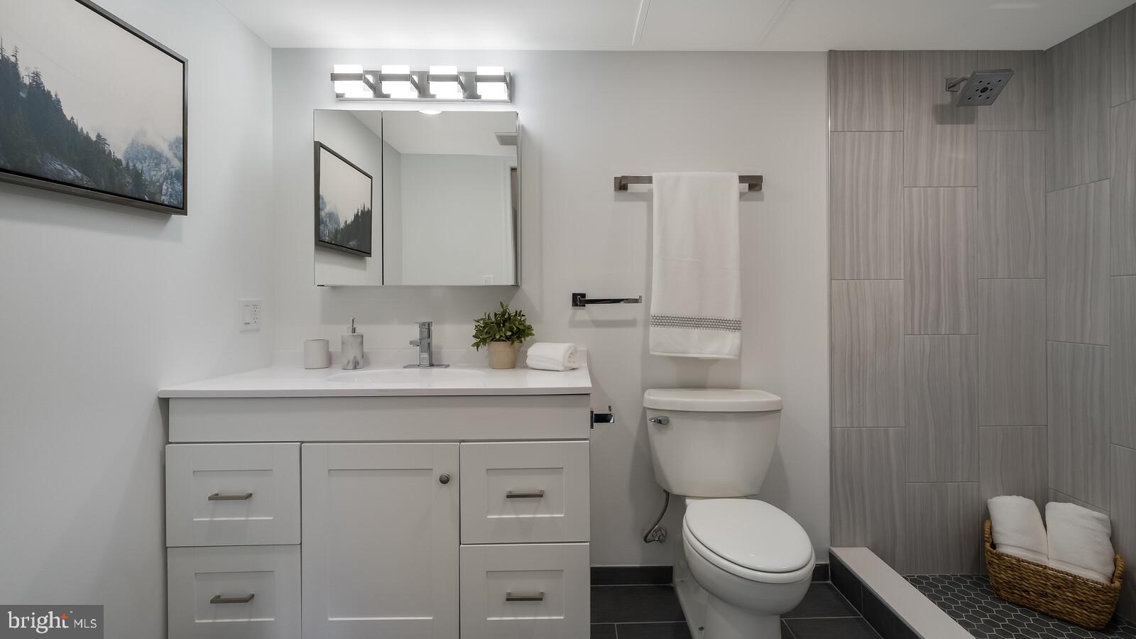1825 Callowhill Street, Unit 511 Philadelphia, PA 19130 - Photo 24 of 50 a bathroom with a toilet a sink a mirror and vanity
