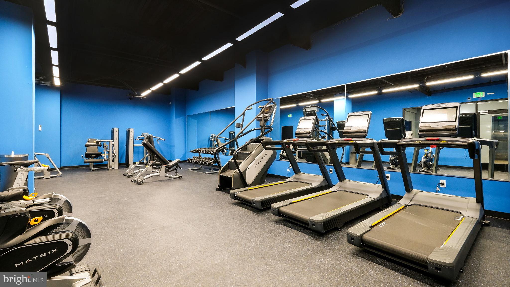 1825 Callowhill Street, Unit 511 Philadelphia, PA 19130 - Photo 31 of 50 a room with gym equipment and a table