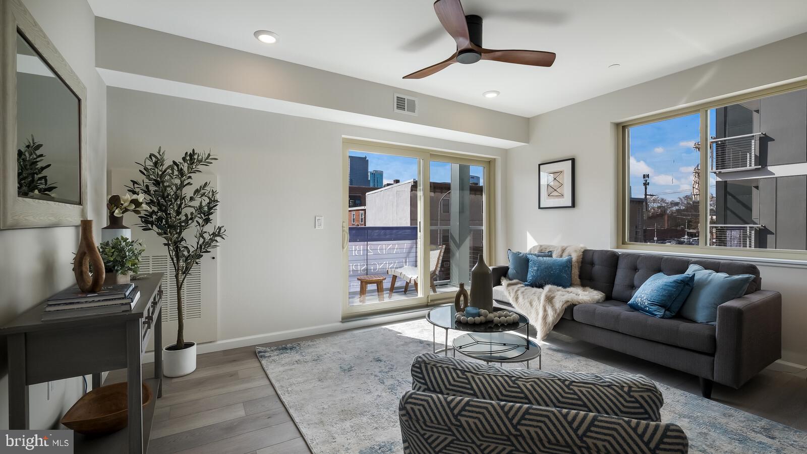 1825 Callowhill Street, Unit 511 Philadelphia, PA 19130 - Photo 10 of 50 a living room with furniture and a potted plant