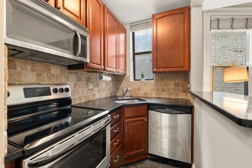 362 Commonwealth Avenue, Unit 6D Boston, MA 02115 - Photo 3 of 15 a kitchen with a stove microwave and sink