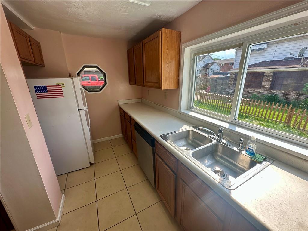 1023 Burtner Road Natrona Heights, PA 15065 - Photo 11 of 33 a kitchen with a sink a stove and a refrigerator