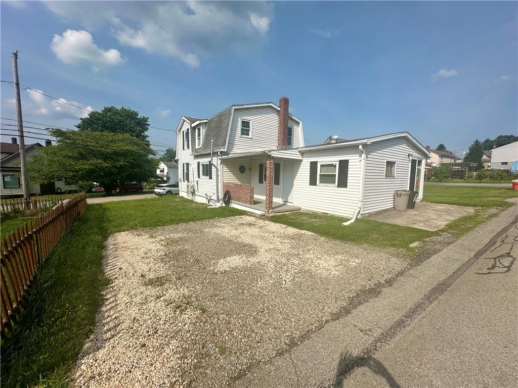 1023 Burtner Road Natrona Heights, PA 15065 - Photo 29 of 33 a front view of a house with a garden and yard