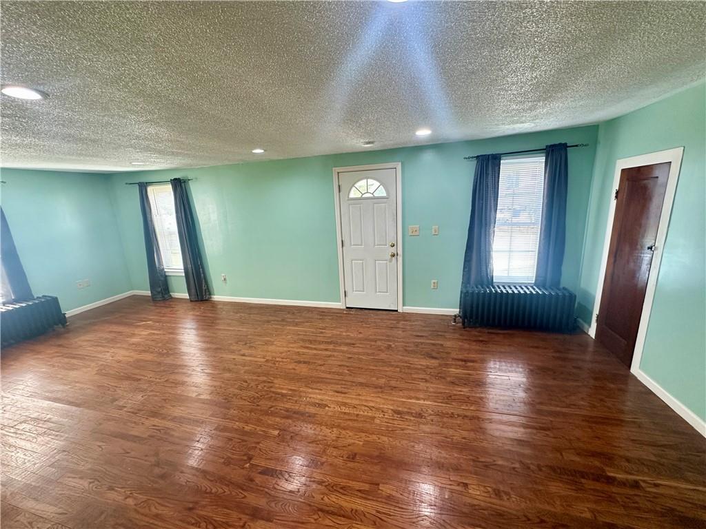 1023 Burtner Road Natrona Heights, PA 15065 - Photo 5 of 33 a view of an empty room with window and wooden floor
