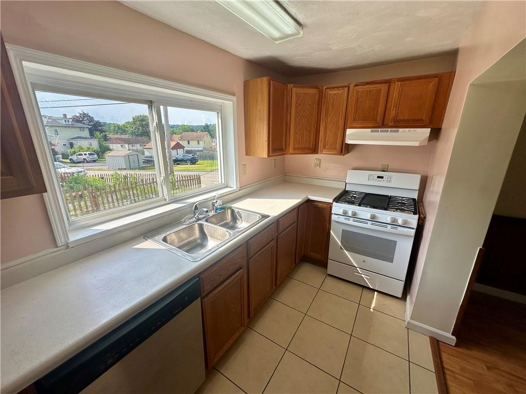 1023 Burtner Road Natrona Heights, PA 15065 - Photo 10 of 33 a kitchen with a sink stove top oven and cabinets
