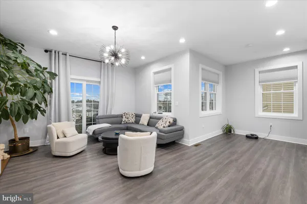a living room with furniture window and wooden floor