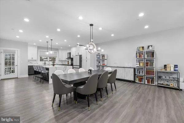 a dining room with furniture and wooden floor