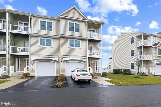 a car parked in front of a white house