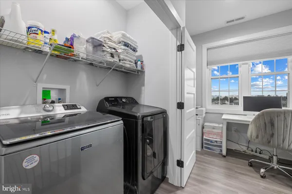 a utility room with closet dryer and washer