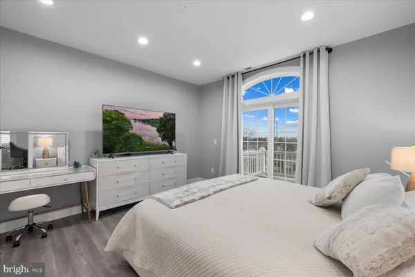 a bedroom with a large bed and a flat screen tv