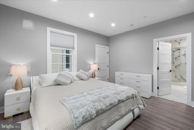 a bedroom with a bed and a lamp