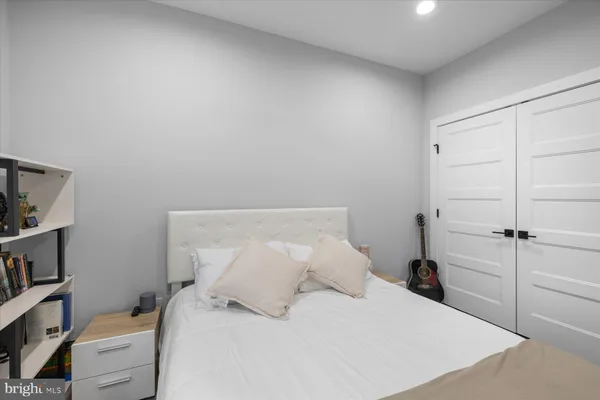 a bedroom with a bed and a book shelf