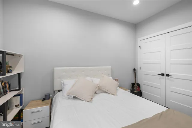 a bedroom with a bed and a book shelf