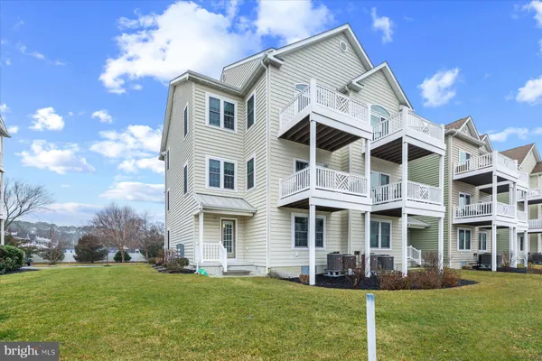 a front view of a building with a garden