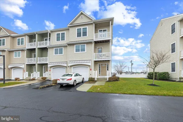 a car parked in front of a white building