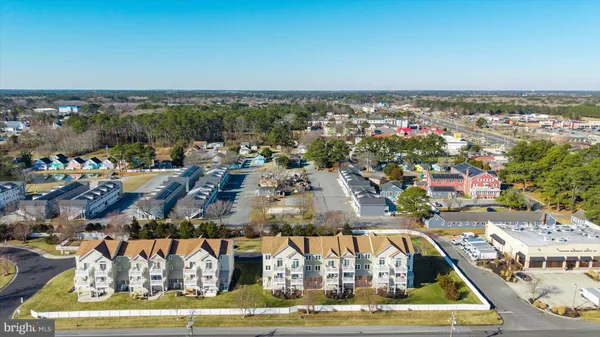 an aerial view of multiple houses with yard