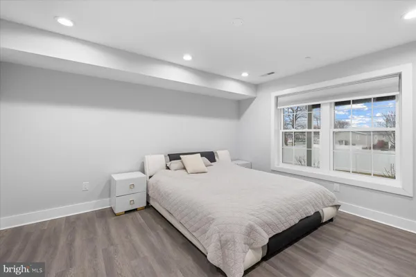 a bedroom with a bed and a large window