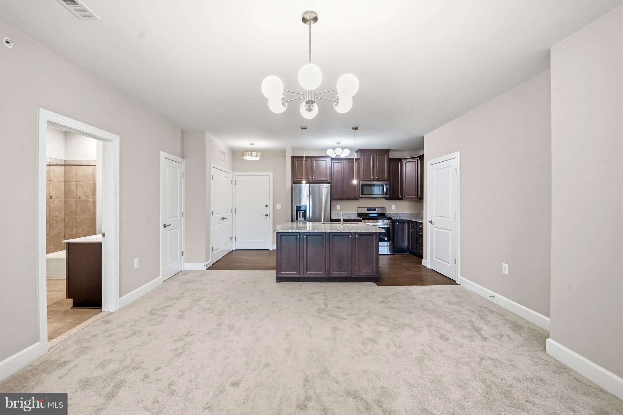 10520 Resort Road, Unit 303 Ellicott City, MD 21042 - Photo 6 of 11 a large kitchen with a refrigerator a stove a sink and a dishwasher