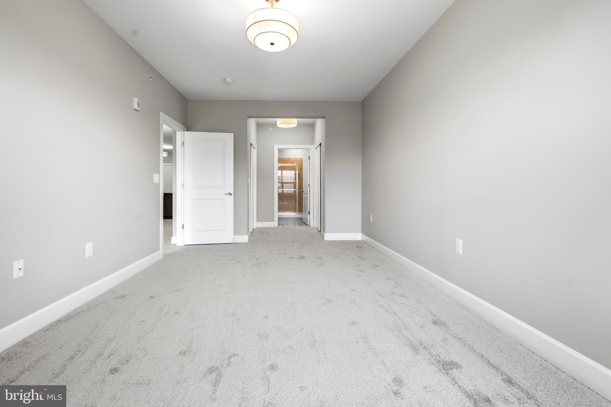 10520 Resort Road, Unit 303 Ellicott City, MD 21042 - Photo 8 of 11 an empty room with windows and closet