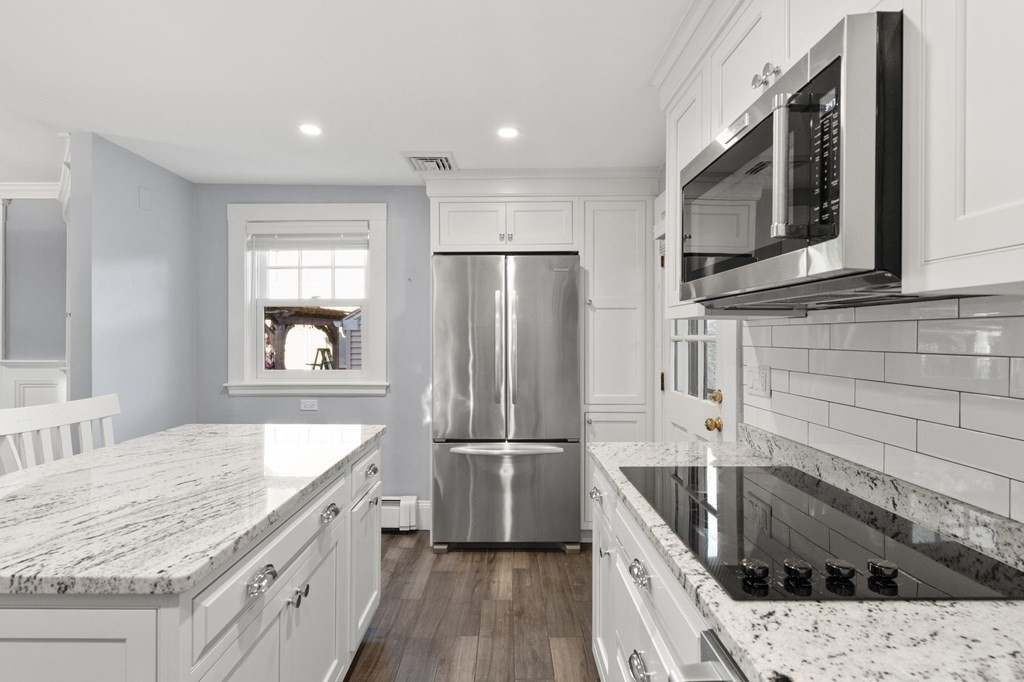 63 Oak Ridge Road Medford, MA 02155 - Photo 24 of 40 a kitchen with granite countertop a refrigerator stove and sink