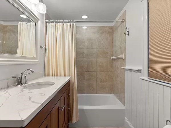 63 Oak Ridge Road Medford, MA 02155 - Photo 35 of 40 a bathroom with a granite countertop sink a mirror a shower and a bathtub