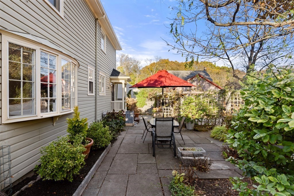 63 Oak Ridge Road Medford, MA 02155 - Photo 6 of 40 a view of a tables and chairs under an umbrella