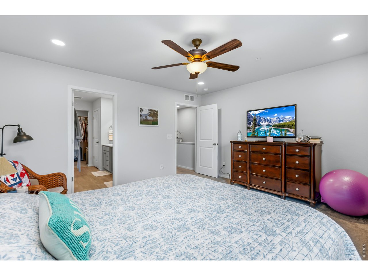 6609 4th St Road, Unit 4 Greeley, CO 80634 - Photo 22 of 41 a bedroom with a bed and a chandelier