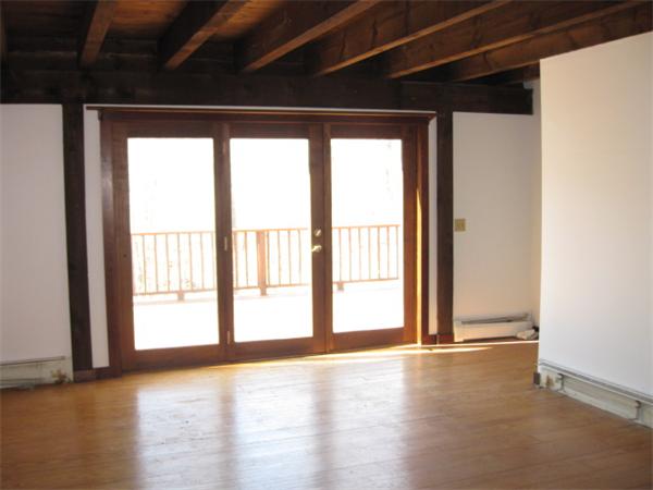 120 Rocky Hill Road Scituate, RI 02857 - Photo 3 of 14 a view of an empty room with a window and wooden floor