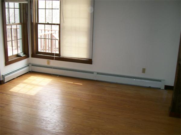 120 Rocky Hill Road Scituate, RI 02857 - Photo 10 of 14 an empty room with wooden floor and windows