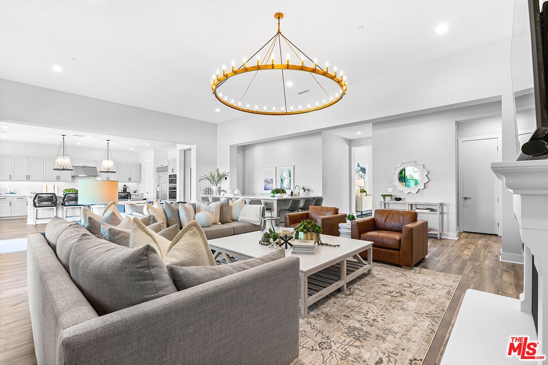 80464 Old Rnch Trail North La Quinta, CA 92253 - Photo 11 of 42 a living room with furniture a rug and a chandelier