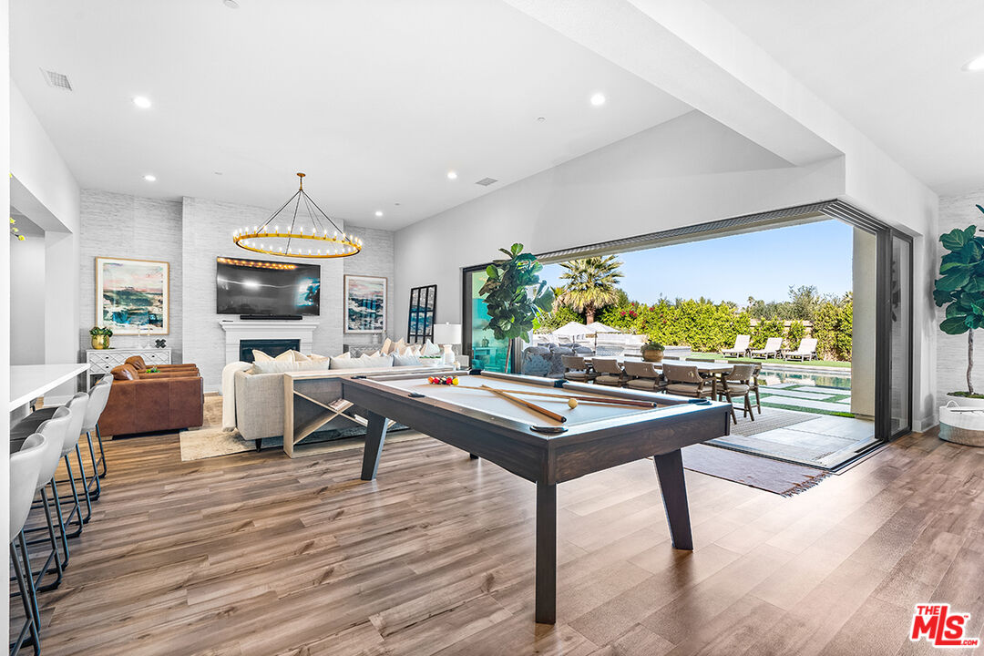 80464 Old Rnch Trail North La Quinta, CA 92253 - Photo 13 of 42 a living room with furniture a rug and a large window