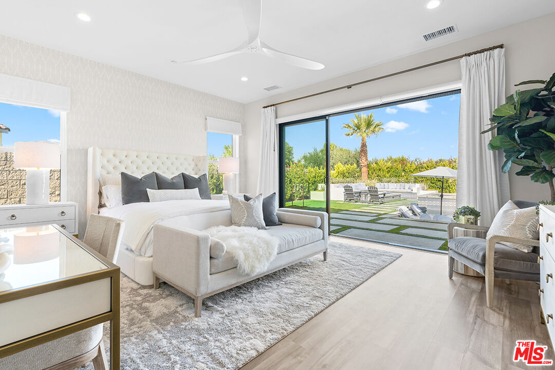 80464 Old Rnch Trail North La Quinta, CA 92253 - Photo 19 of 42 a bedroom with a large bed and a large window