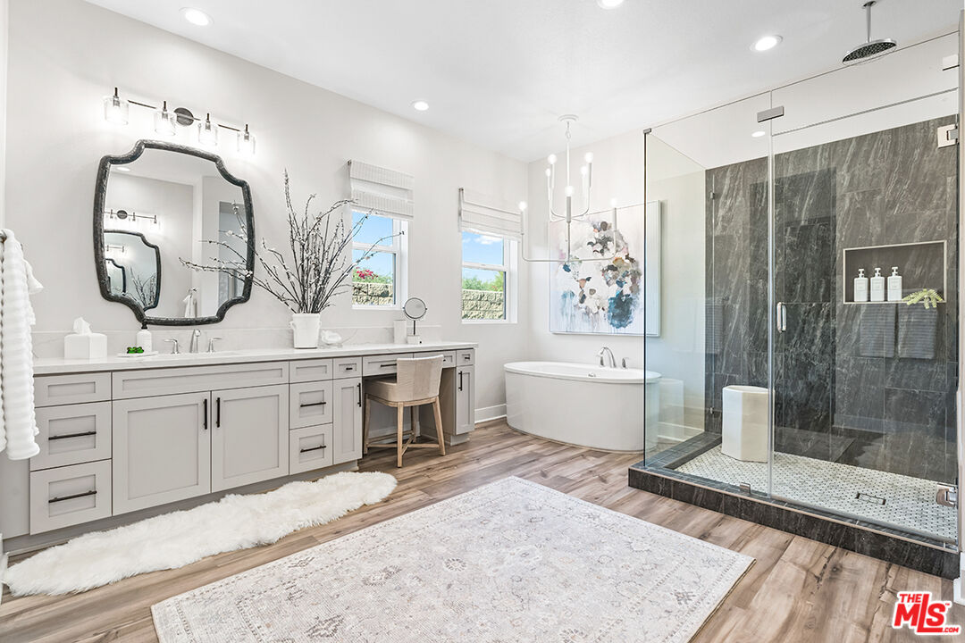 80464 Old Rnch Trail North La Quinta, CA 92253 - Photo 21 of 42 a spacious bathroom with a double vanity sink a mirror a bathtub and shower