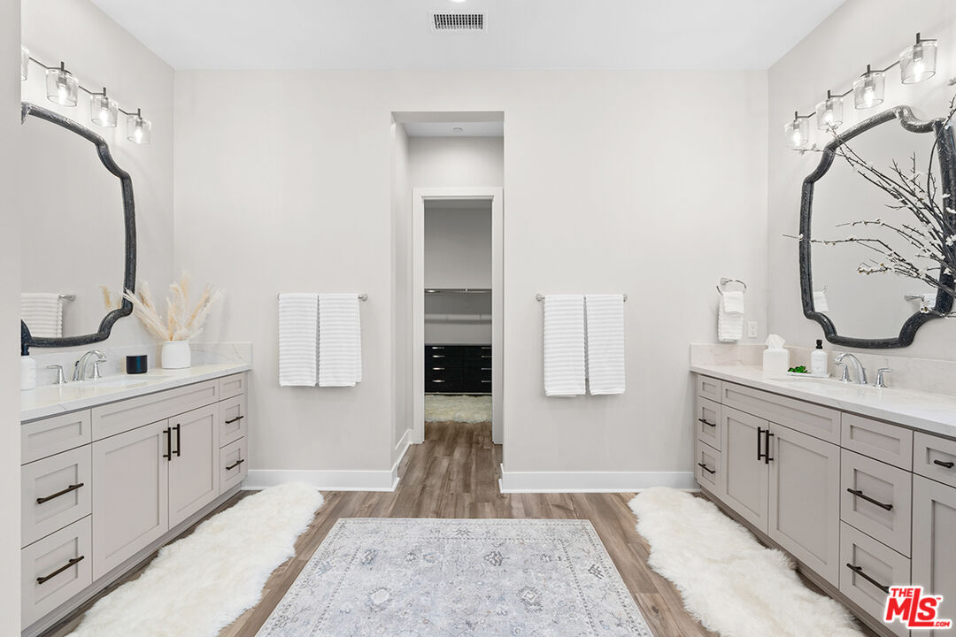 80464 Old Rnch Trail North La Quinta, CA 92253 - Photo 22 of 42 a spacious bathroom with a double vanity sink and mirror