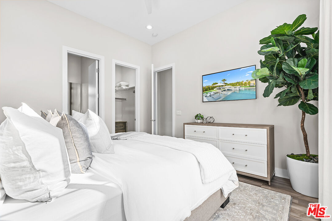 80464 Old Rnch Trail North La Quinta, CA 92253 - Photo 25 of 42 a bedroom with a bed and a potted plant
