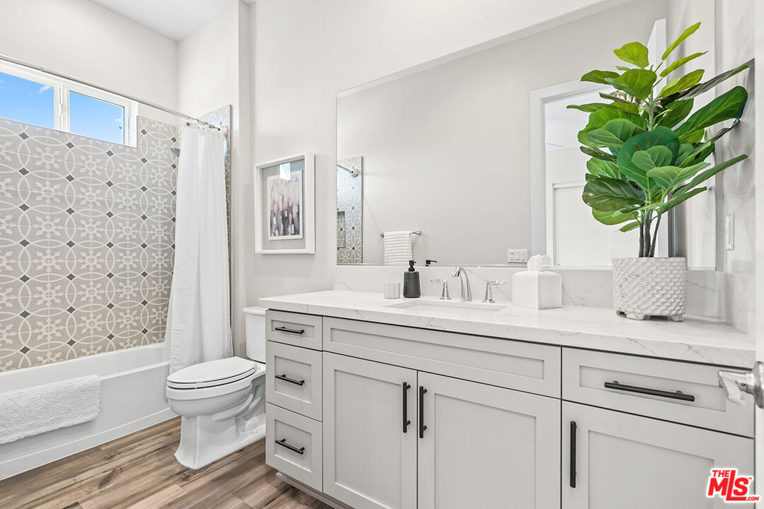 80464 Old Rnch Trail North La Quinta, CA 92253 - Photo 28 of 42 a bathroom with a sink a toilet and a large mirror