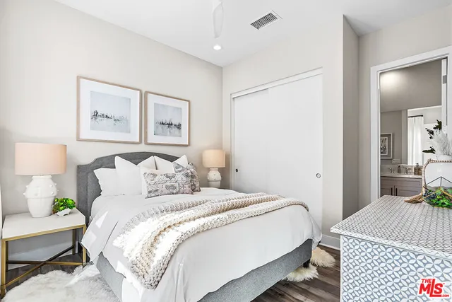 a bedroom with a bed and a couch