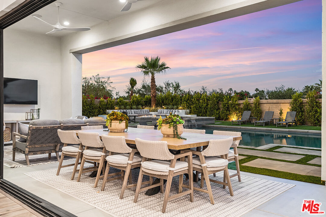 80464 Old Rnch Trail North La Quinta, CA 92253 - Photo 3 of 42 a dining room with furniture and a floor to ceiling window