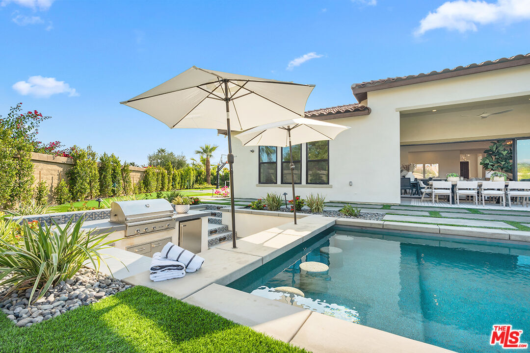 80464 Old Rnch Trail North La Quinta, CA 92253 - Photo 7 of 42 a view of a patio with swimming pool table and chairs