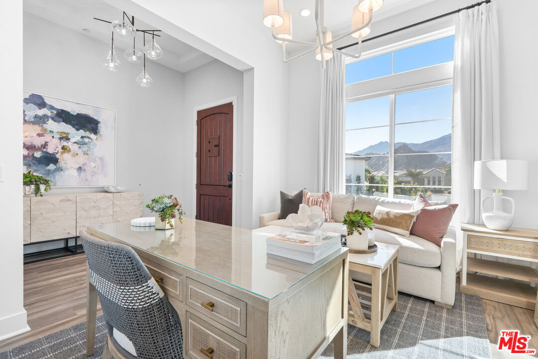 80464 Old Rnch Trail North La Quinta, CA 92253 - Photo 8 of 42 a dining room with furniture a chandelier and wooden floor