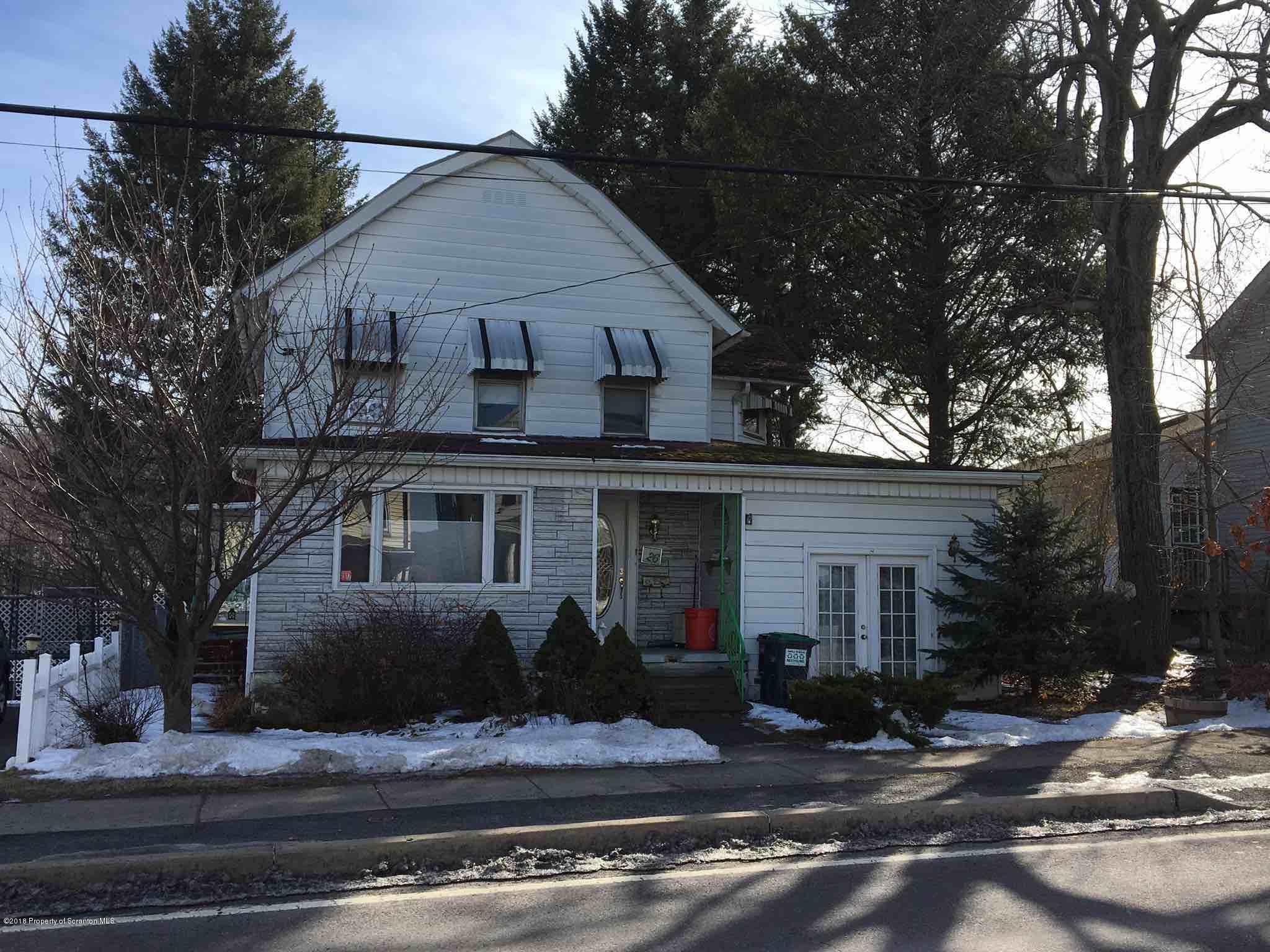 26 Main Street Inkerman, PA 18640 - Photo 2 of 16 a view of a white house with large windows and a large tree