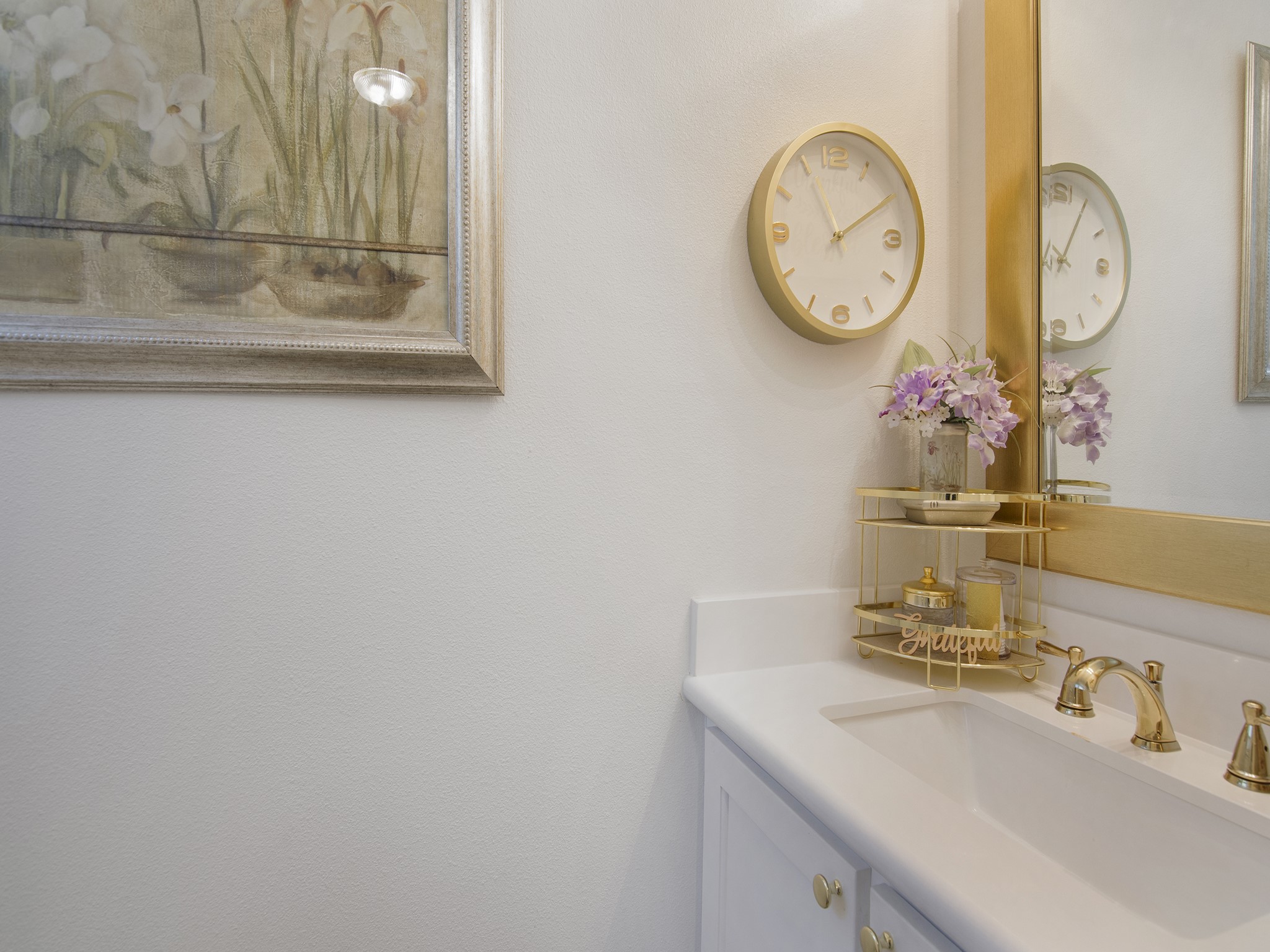 532 Raleigh Drive Conroe, TX 77302 - Photo 18 of 40 Stylish half bathroom thoughtfully designed featuring quartz countertop and gold-accented vanity with matching framed mirror.