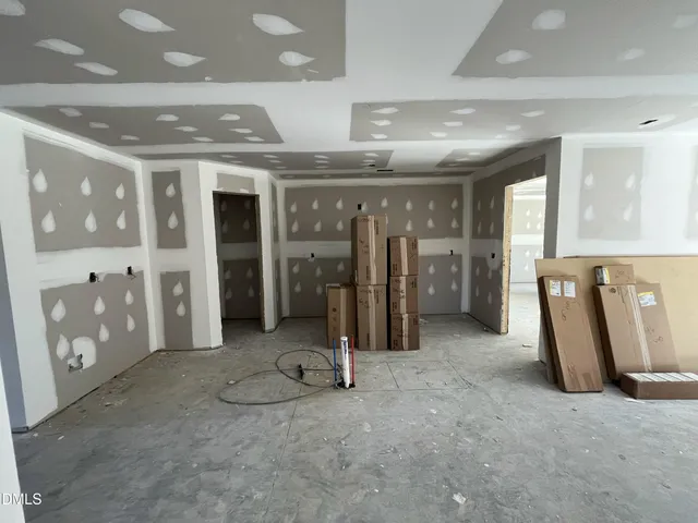 a view of a hallway with stainless steel appliances