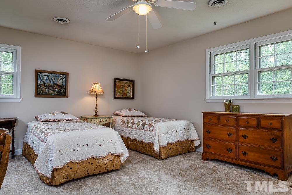 2942 Buckingham Road Durham, NC 27707 - Photo 16 of 25 a spacious bedroom with two beds and painting on the wall