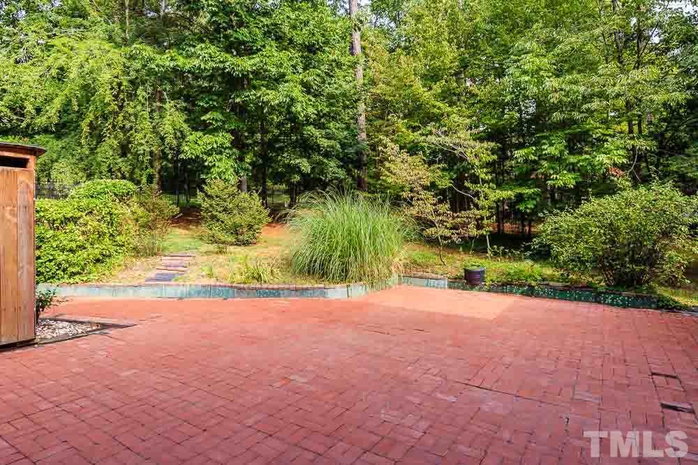 2942 Buckingham Road Durham, NC 27707 - Photo 22 of 25 a view of a yard with plants and trees