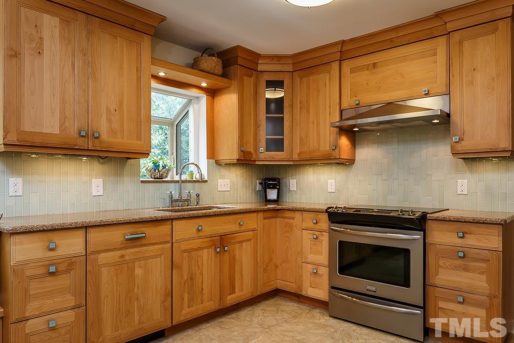 2942 Buckingham Road Durham, NC 27707 - Photo 6 of 25 a kitchen with stainless steel appliances granite countertop a stove and a microwave