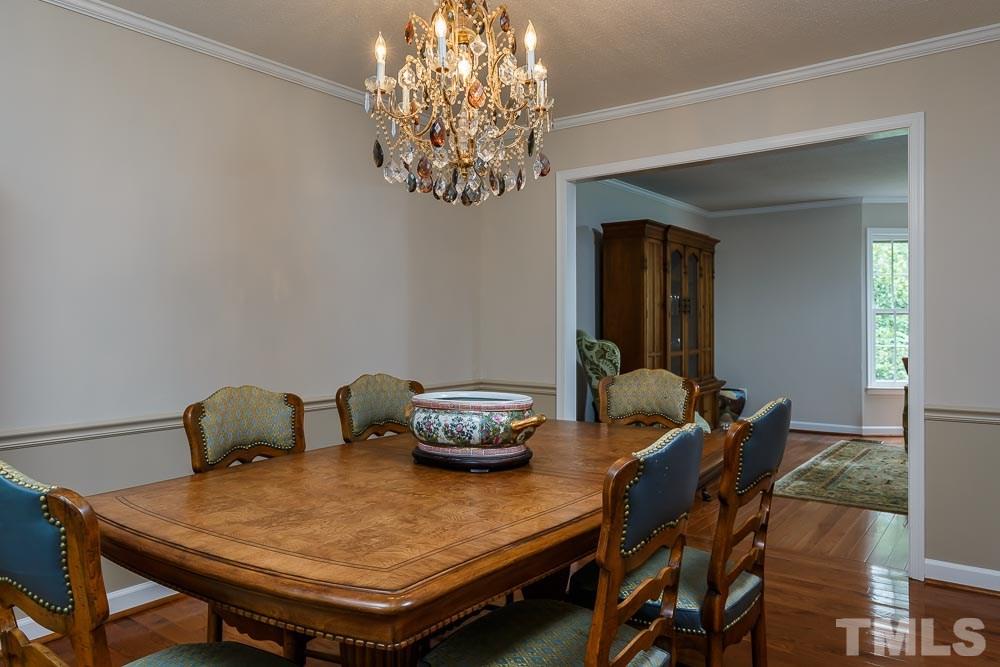 2942 Buckingham Road Durham, NC 27707 - Photo 8 of 25 a view of a dining room with furniture and chandelier