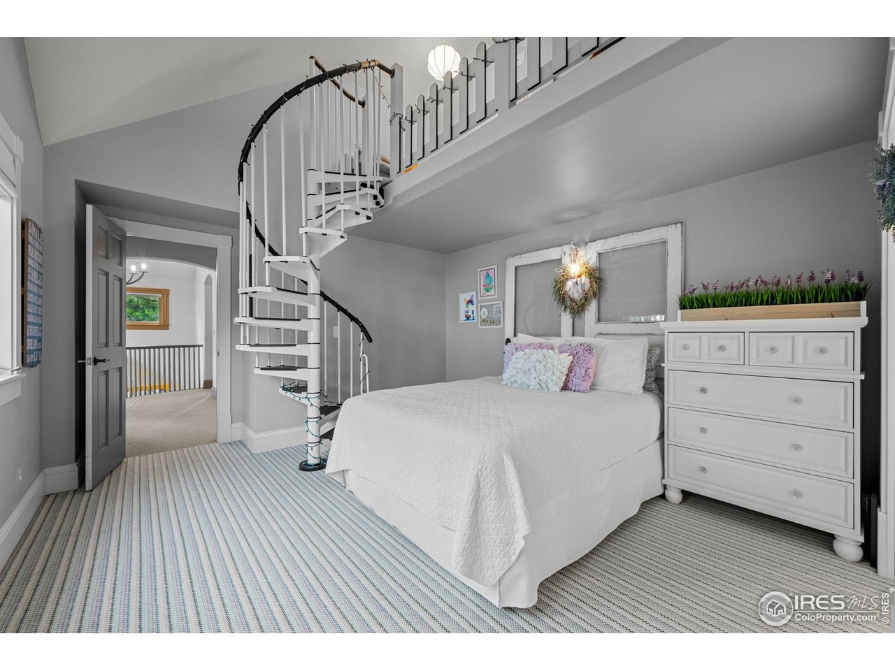 820 6th Street Boulder, CO 80302 - Photo 19 of 37 a bedroom with a large bed and a chandelier