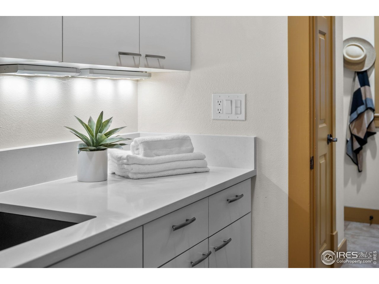 820 6th Street Boulder, CO 80302 - Photo 21 of 29 a bathroom with a sink a mirror and cabinets