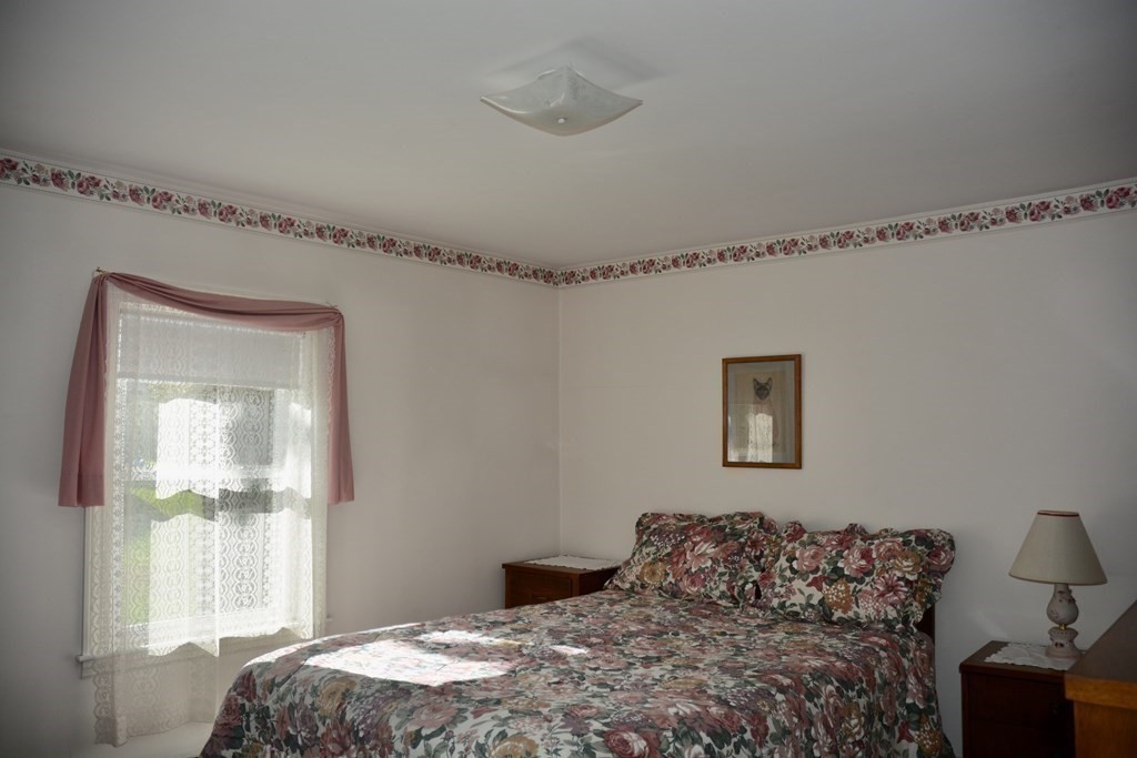 48 Randolph Street Canton, MA 02021 - Photo 13 of 21 a bedroom with a bed and a window